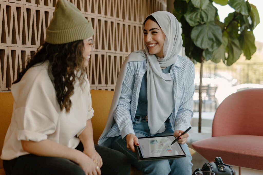 Two girls looking at each other laughing